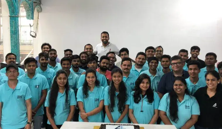 The Everest Fleet team standing together in matching blue T-shirts
