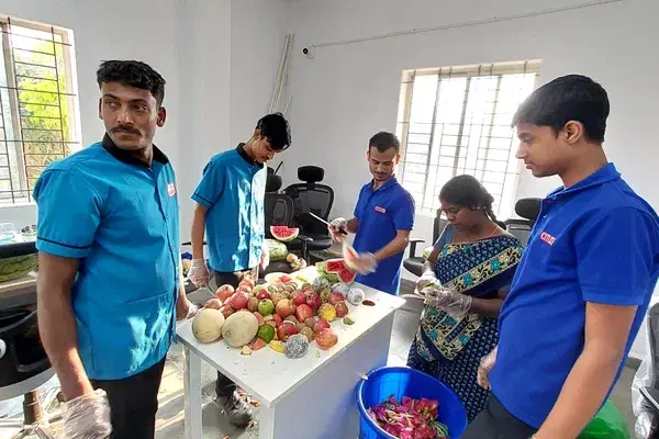 Colleagues preparing fruit for a team activity