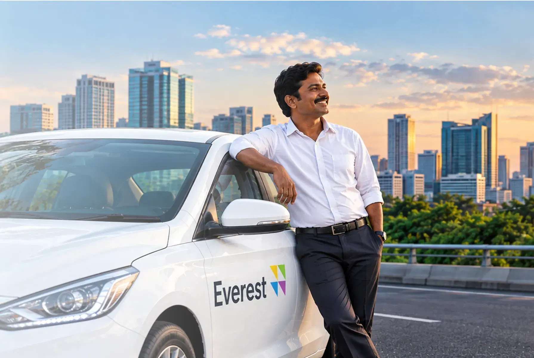 An Everest driver leaning on his car with the city skyline behind him